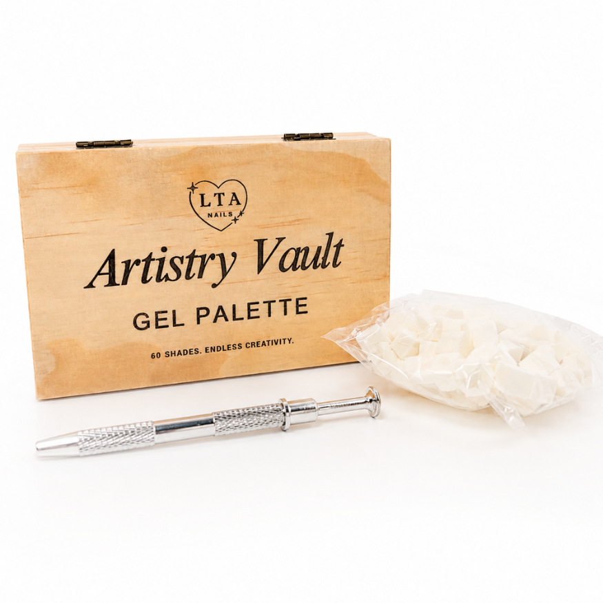 LTA Nails Artistry Vault Gel Palette kit, featuring a light wood presentation box, a silver metal nail stamping tool, and a clear plastic bag of white gel nail powders on a white background.